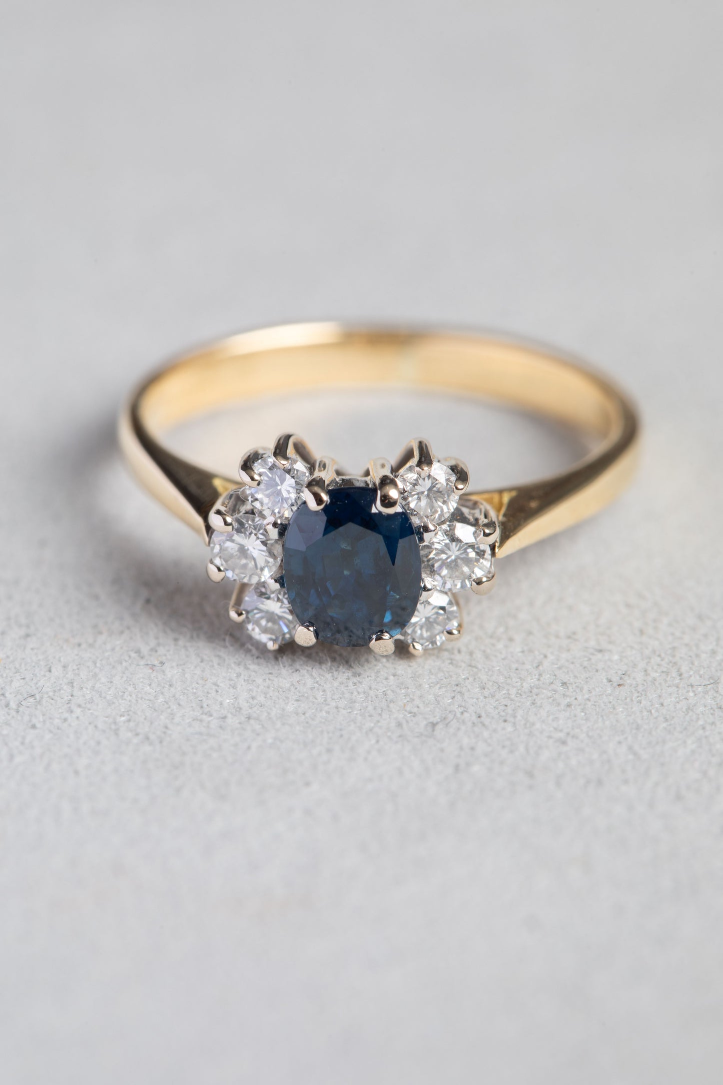 Oval Sapphire and Round Brilliant Cut Diamond Cluster Ring