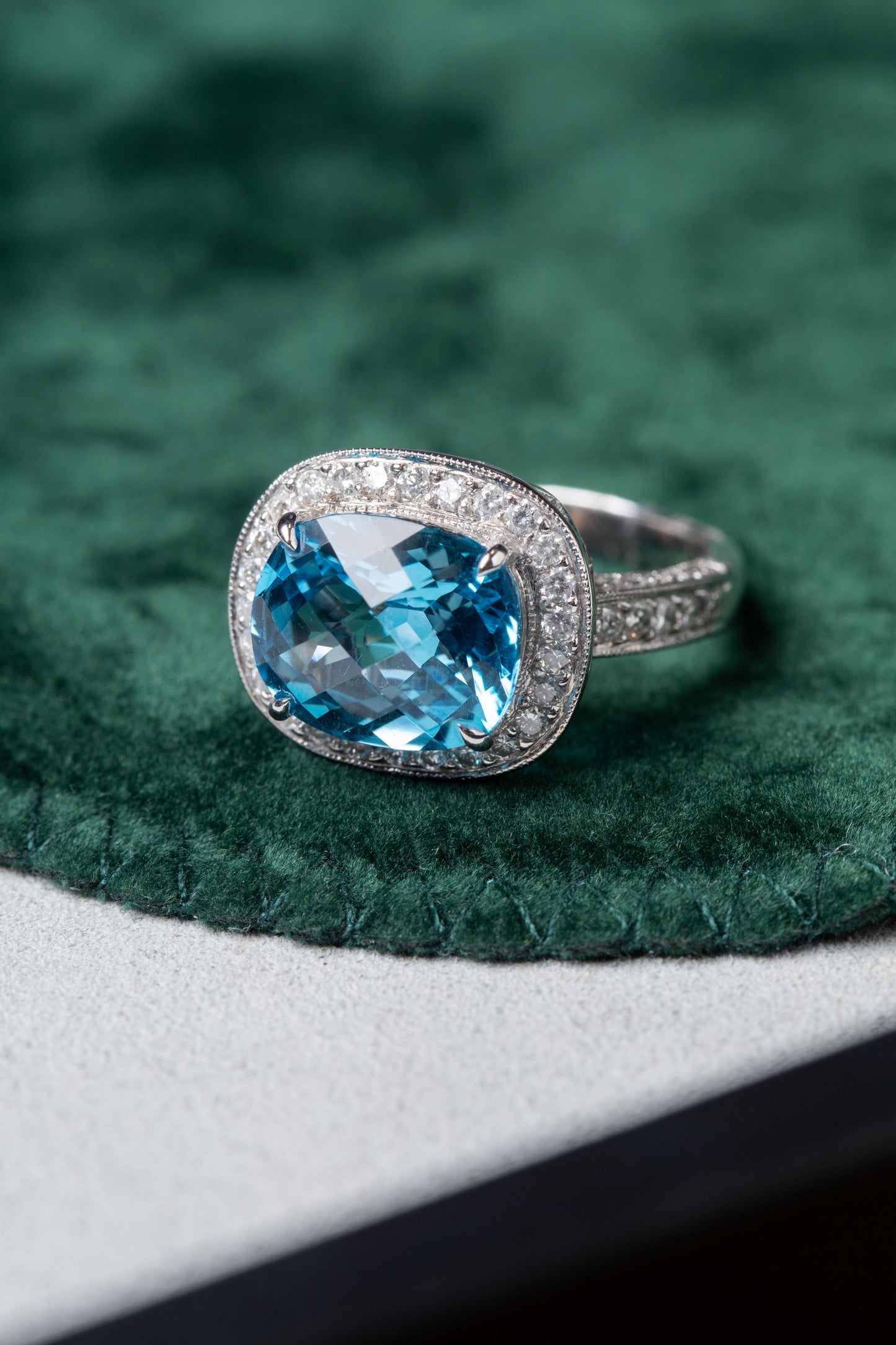 Blue Topaz with halo of Diamonds and Diamond set shoulders Ring