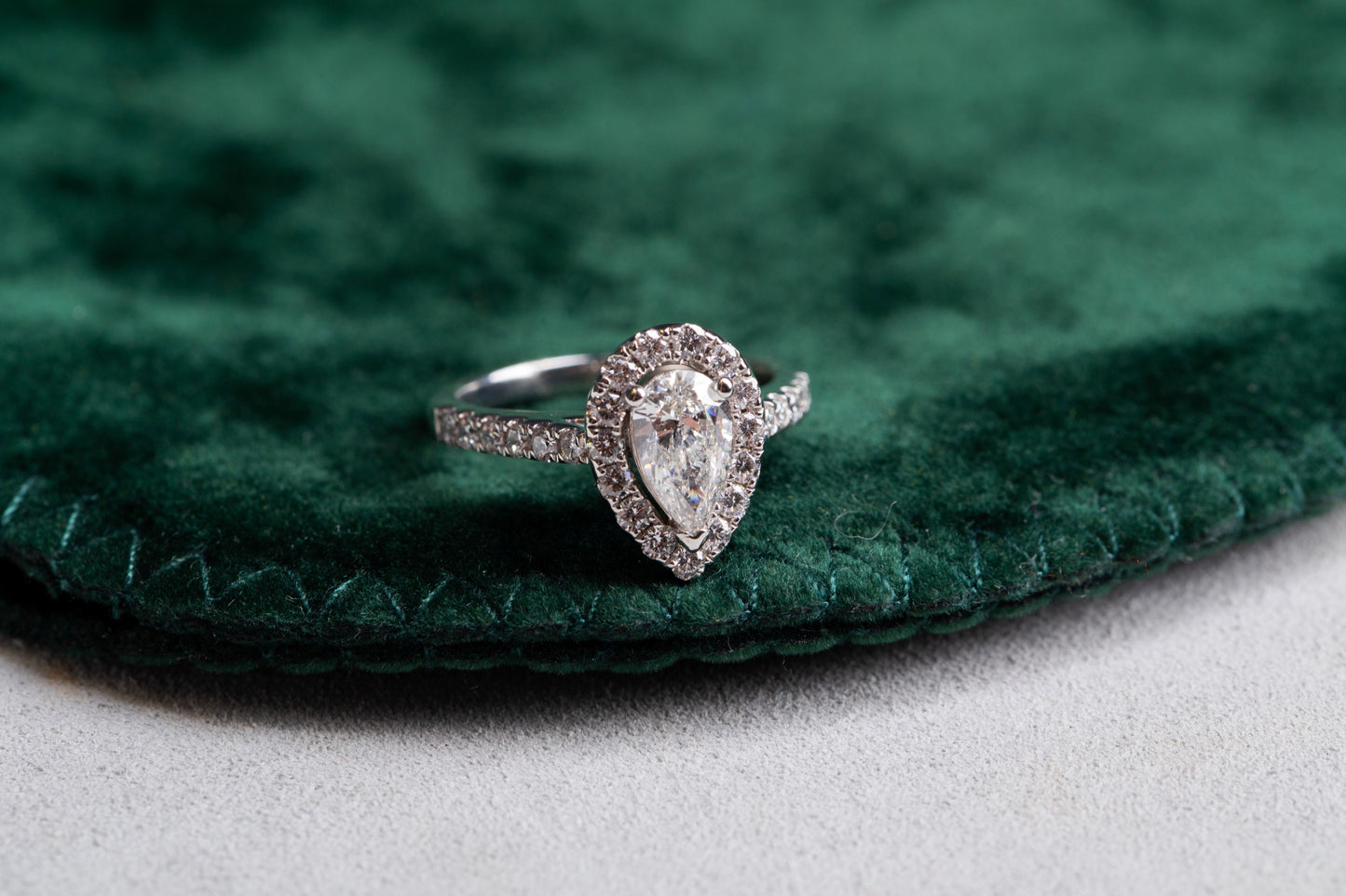 Pear Cut Diamond with halo and Diamond set shoulders