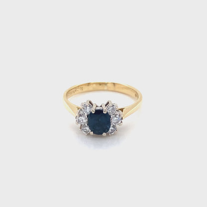 Oval Sapphire and Round Brilliant Cut Diamond Cluster Ring