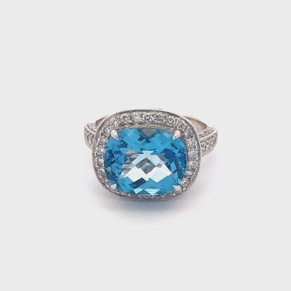 Blue Topaz with halo of Diamonds and Diamond set shoulders Ring