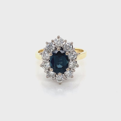 Oval Sapphire and Round Brilliant Cut Diamond Cluster Ring